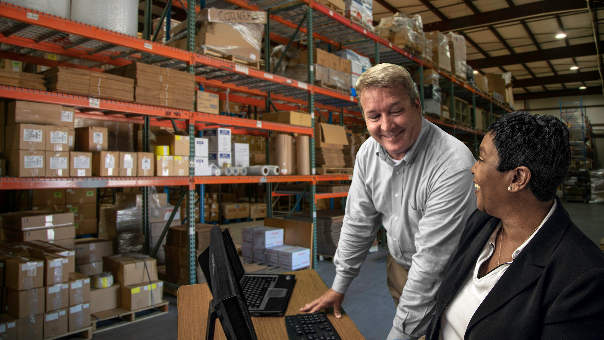 Employees at desk inside warehouse